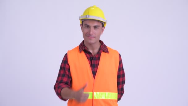 Young happy Hispanic man construction worker giving thumbs up — Stock Video