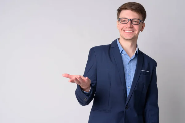 Portret młodego wesołego biznesmen śmiejąc się z ręką podniesioną — Zdjęcie stockowe