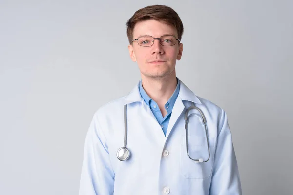 Portrait of young handsome man doctor with eyeglasses — Stock Photo, Image