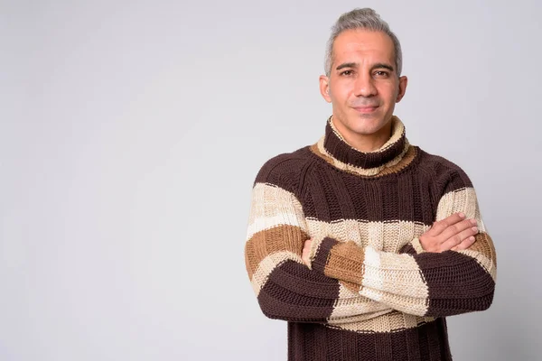 Portrait of handsome Persian man with arms crossed ready for winter — Stock Photo, Image