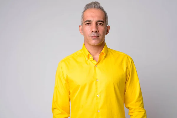 Portrait of handsome Persian businessman wearing yellow shirt — Stock Photo, Image