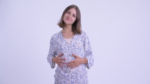 Happy young pregnant woman smiling with arms crossed — Stock Video