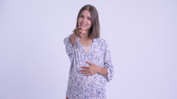 Happy young pregnant woman pointing at camera — Stock Video