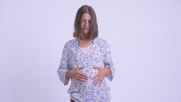 Jovem grávida com o dedo nos lábios — Vídeo de Stock