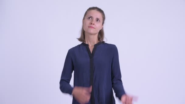 Confused young businesswoman choosing between thumbs up and thumbs down — Stock Video