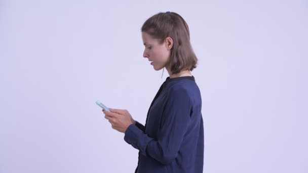 Profile view of happy young businesswoman with phone being taken away — Stock Video