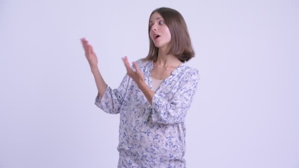 Happy young pregnant woman presenting something — Stock Video
