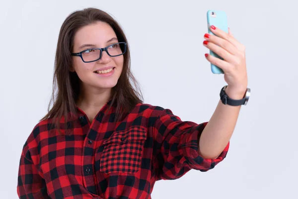 Portrait of young happy hipster woman taking selfie — Stock Photo, Image