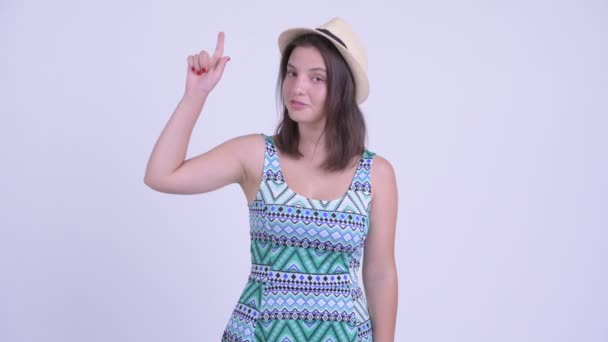 Happy young beautiful tourist woman pointing up — Stock Video