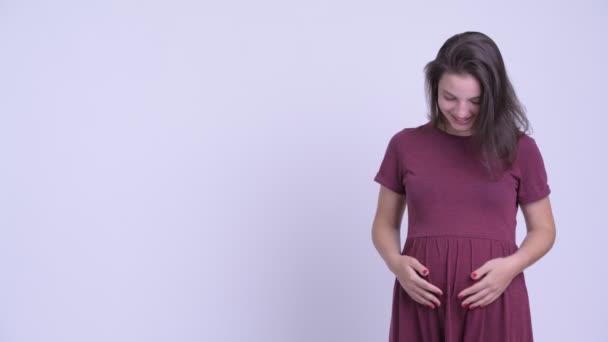 Happy young beautiful pregnant woman showing something — Stock Video