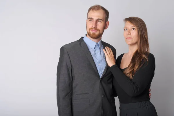Portrait of young business couple thinking together