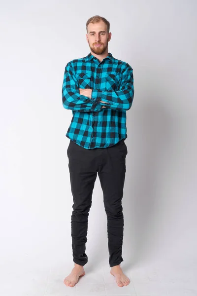 Full body shot of young bearded hipster man with arms crossed — Stock Photo, Image