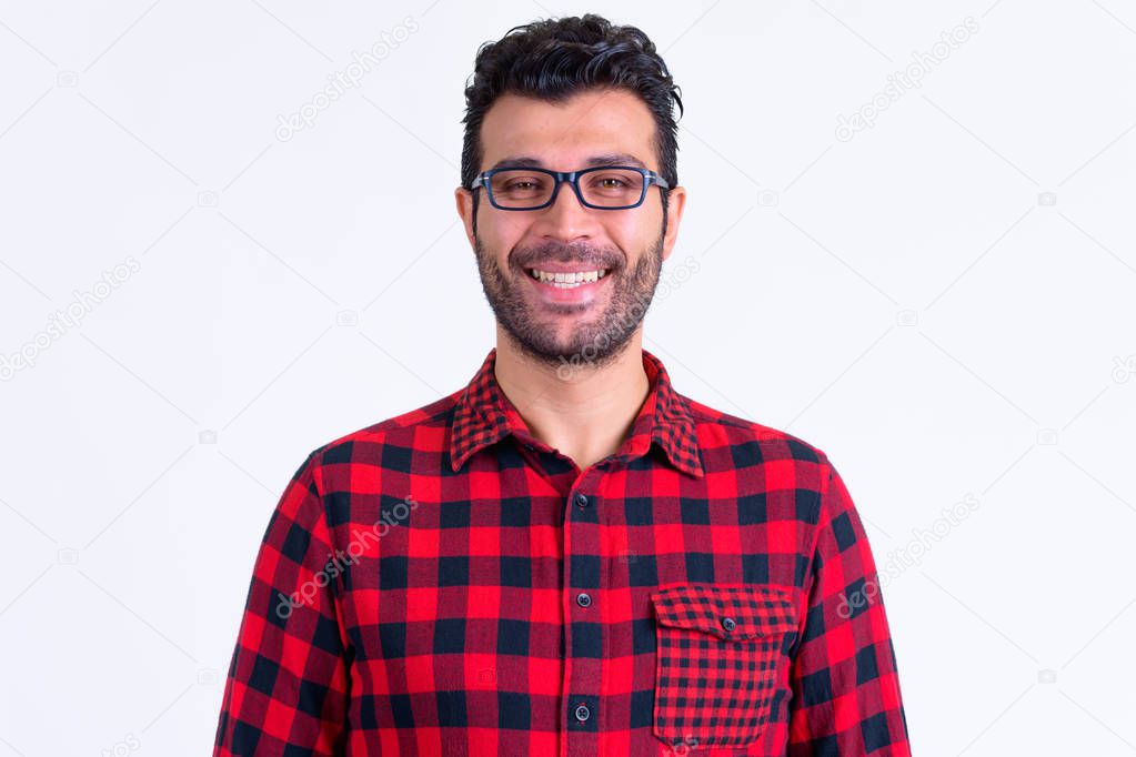 Face of happy bearded Persian hipster man smiling