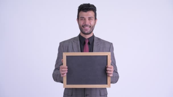 Счастливый бородатый персидский бизнесмен держит доску — стоковое видео