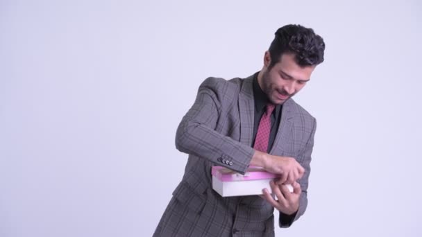 Happy bearded Persian businessman opening gift box — Stock Video