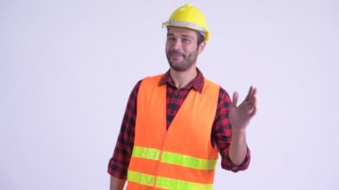 Mutlu sakallı Pers adam inşaat işçisi el sallayarak