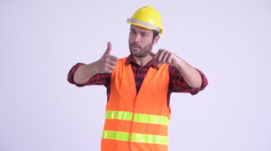 Şaşkın sakallı Pers adam inşaat işçisi başparmak yukarı ve başparmak aşağı arasında seçim