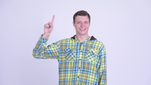 Happy young handsome man pointing up — Stock Video
