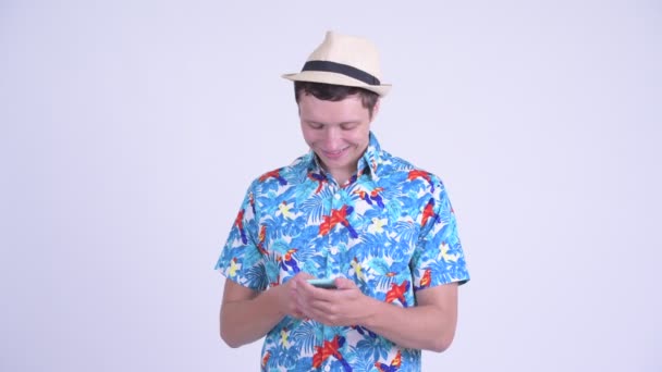 Happy young handsome tourist man using phone — Stock Video