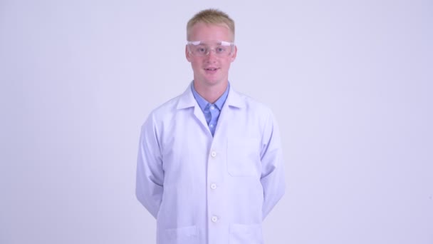 Happy young blonde man doctor with protective glasses — Stock Video