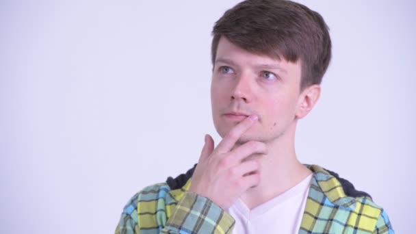 Face of happy young handsome man thinking and looking up — Stock Video