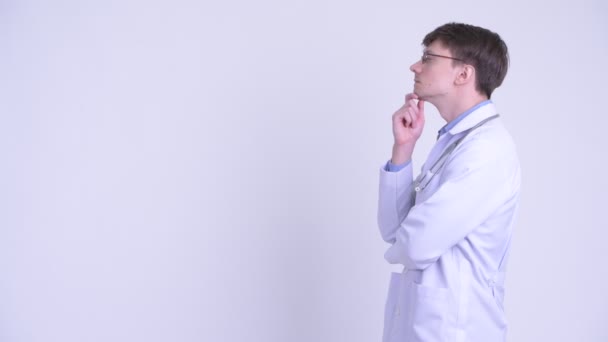 Mutlu genç yakışıklı adam doktor düşünme profil görünümü — Stok video