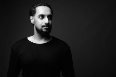 Young bearded Indian man in black and white