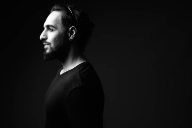 Young bearded Indian man in black and white