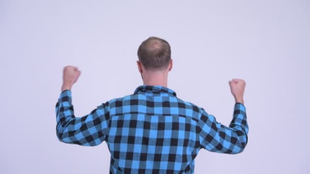 Rear view of happy hipster man with fists raised — Stock Video