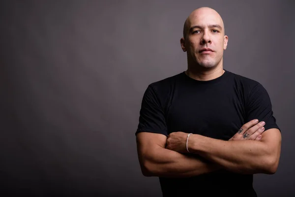 Portrait of handsome bald man against gray background — Stock Photo, Image