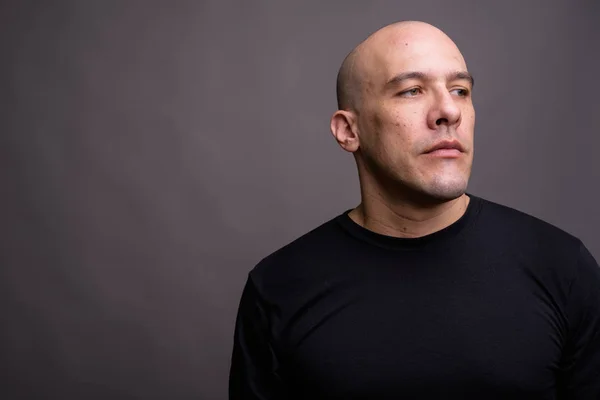 Portrait of handsome bald man against gray background — Stock Photo, Image