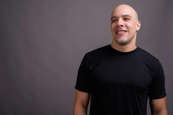 Portrait of handsome bald man against gray background — Stock Photo, Image