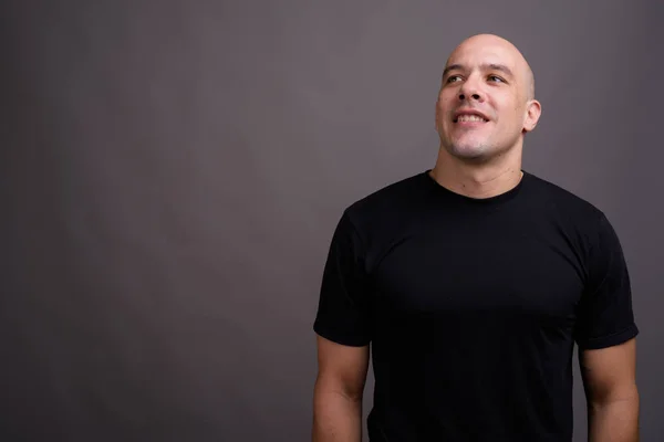 Portrait of handsome bald man against gray background — Stock Photo, Image