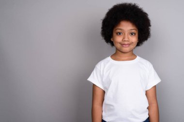Studio shot of young cute African girl against gray background
