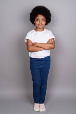 Studio shot of young cute African girl against gray background