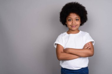 Studio shot of young cute African girl against gray background