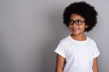 Studio shot of young cute African girl against gray background