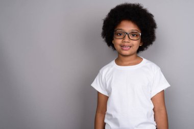 Studio shot of young cute African girl against gray background