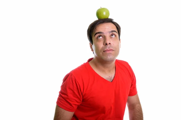Studio Shot Young Persian Man Thinking While Looking Green Apple — Foto Stock