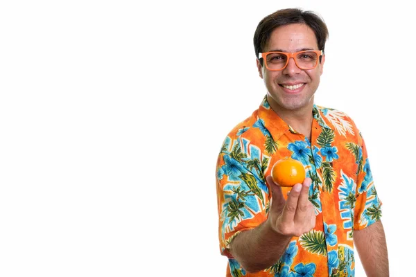 Studio Shot Young Happy Persian Tourist Man Smiling Holding Orange — Stockfoto