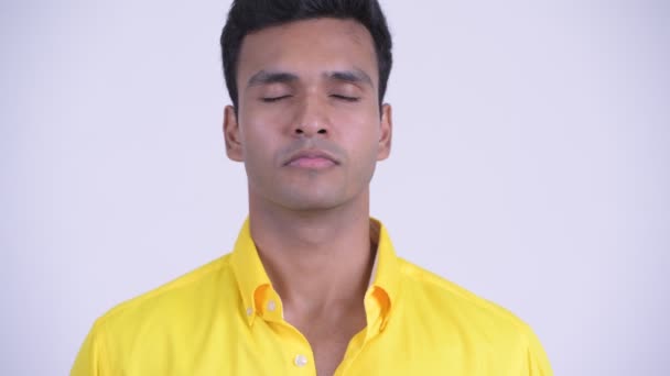 Face of young happy Indian businessman relaxing with eyes closed — Stock Video