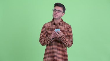 Telefon kullanırken mutlu genç Hispanic hipster adam düşünme