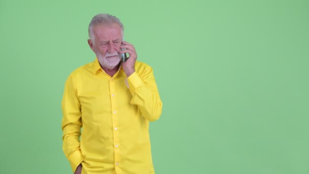 Happy senior bearded businessman talking on the phone — Stock Video