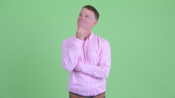 Portrait of happy businessman thinking and looking up — Stock Video