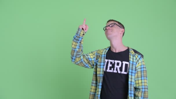 Ritratto di uomo nerd felice che punta in alto e dà i pollici in alto — Video Stock