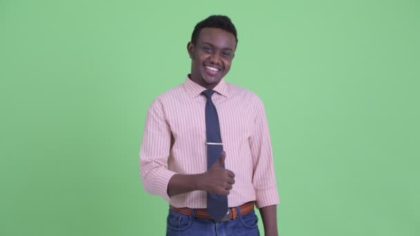 Happy young African businessman giving thumbs up — Stock Video