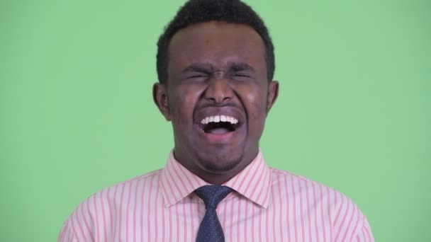 Face of stressed young African businessman looking angry and shouting — Stock Video