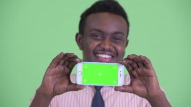 Mutlu genç Afrikalı işadamının yüzü telefon gösteren