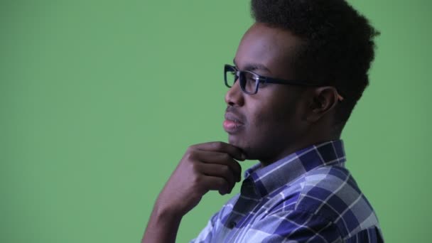 Closeup profile view of happy young African hipster man thinking — Stock Video