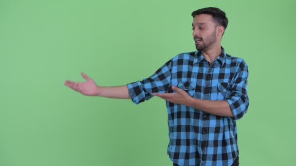 Щасливий молодий бородатий Перська хіпстера людина представляє щось — стокове відео